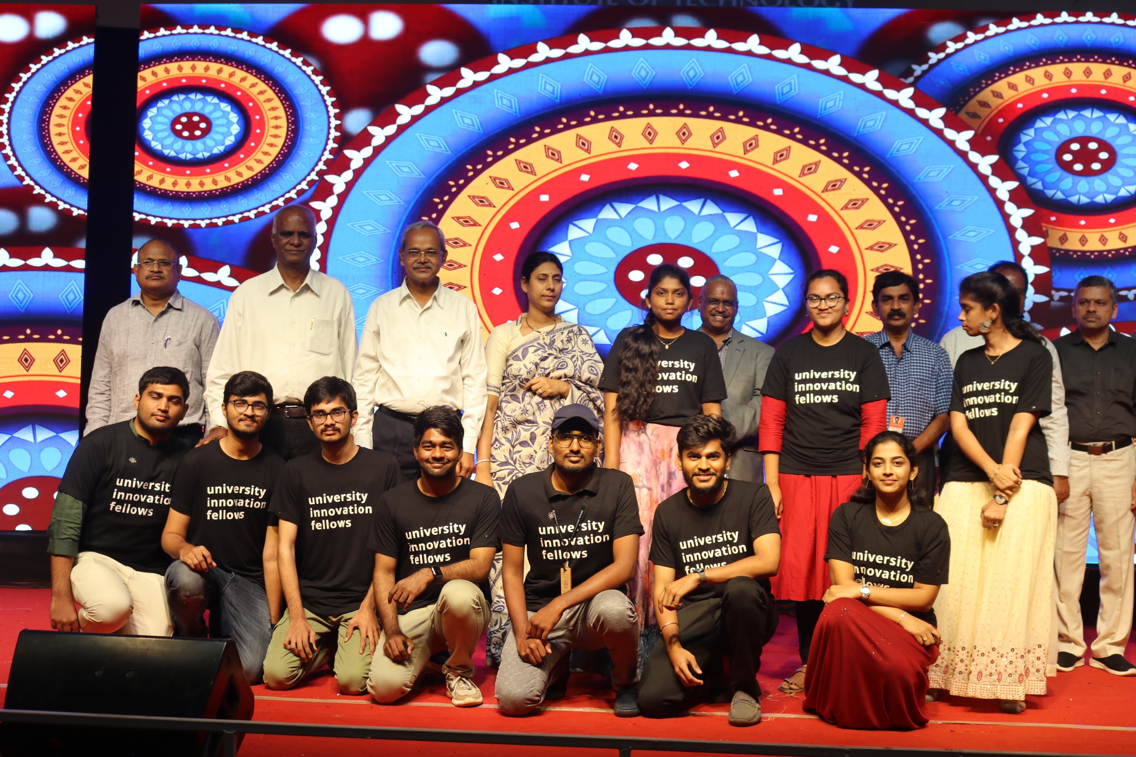 UIF fellows with dignitaries on a colorful cultural event stage