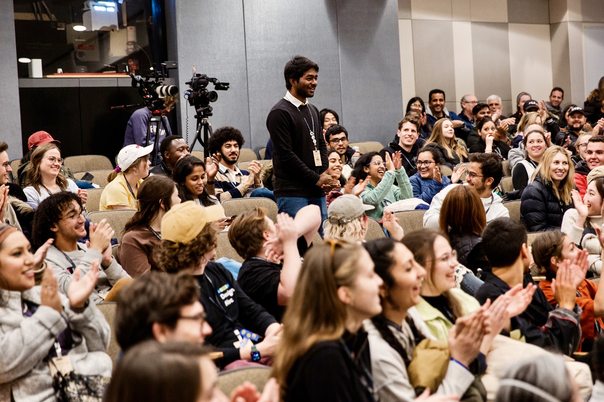 Standing in a packed auditorium during a session